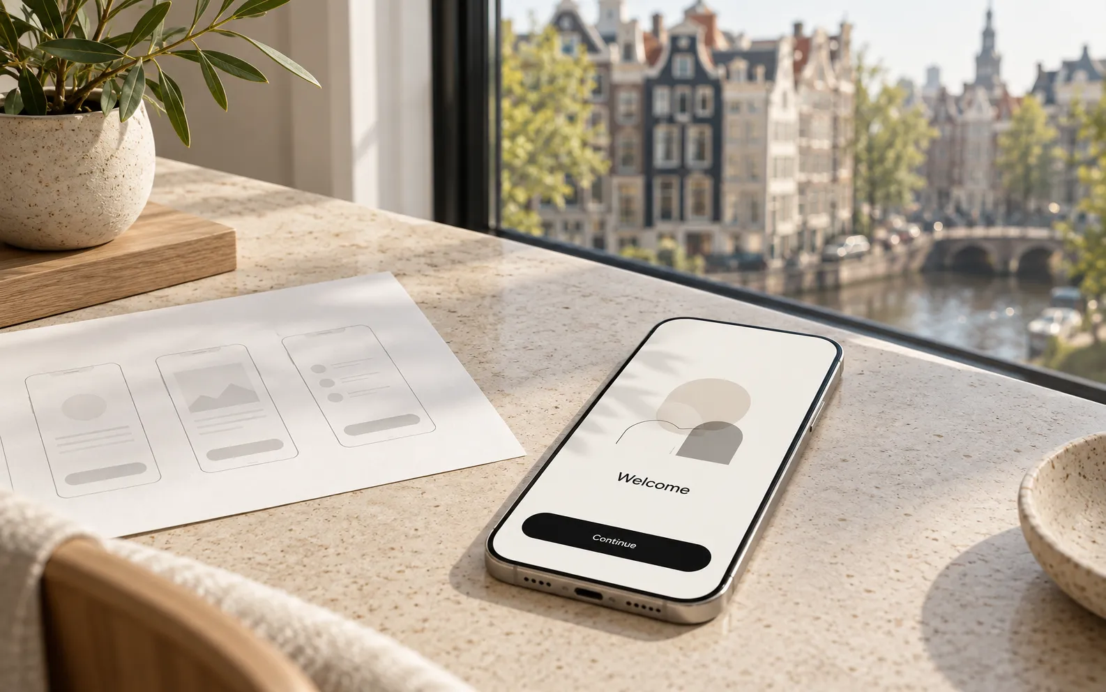 A phone with an onboarding screen in a bright European design studio